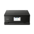Impresora multifunción Canon Pixma TS8750 negra con bandeja de papel y pantalla táctil, diseñada para impresión, escaneo y copiado.